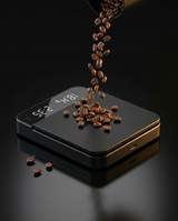 Umbrali Precision Coffee Scale with coffee beans pouring onto the digital display